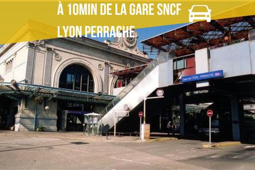 a building with a yellow canopy in front of it at Le Perchoir Tassin - Clim & Proche Campus du numérique in Tassin-la-Demi-Lune