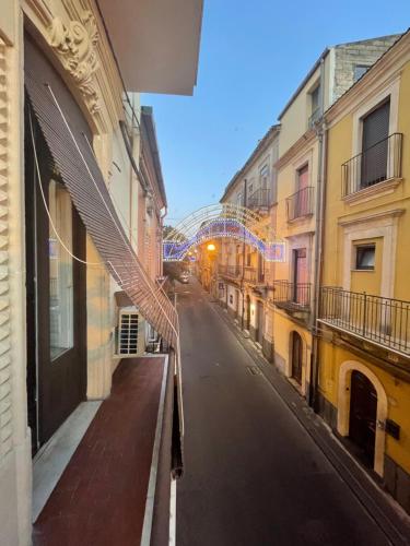 an empty street in an alley with buildings at Dimora Barocca in Militello in Val di Catania