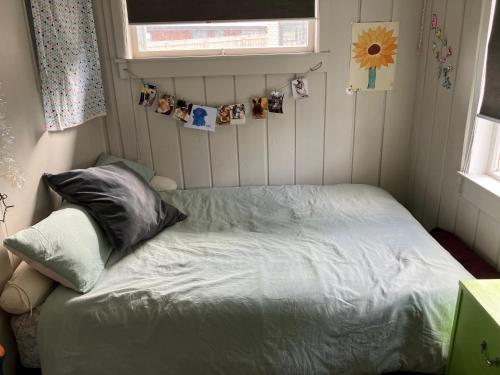 a small bed in a small room with pictures on the wall at Cute little hide out in Taupo