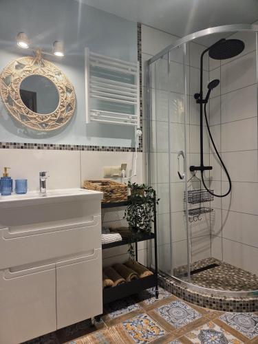 a bathroom with a shower and a sink at Dzintarielas Miera Osta in Pāvilosta