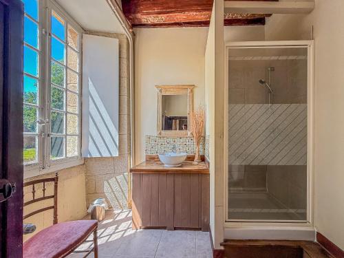 a bathroom with a sink and a glass shower at Manoir des Dryades & Annexes - 29 personnes in Pouligny-Notre-Dame