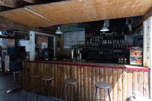 a bar with stools at the counter of a restaurant at Les Rives d’Auzon Mobil-home 6 pers in Lavilledieu
