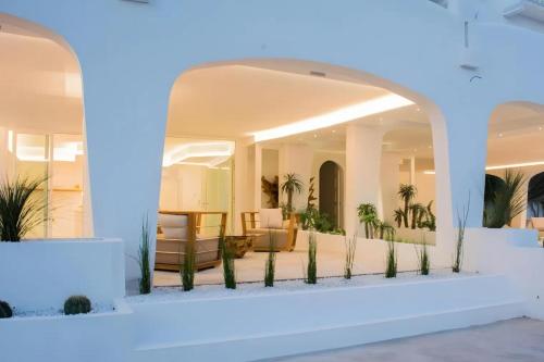 a lobby with palm trees and a blue light at Valentino Luxury Rooms in Porto Cesareo