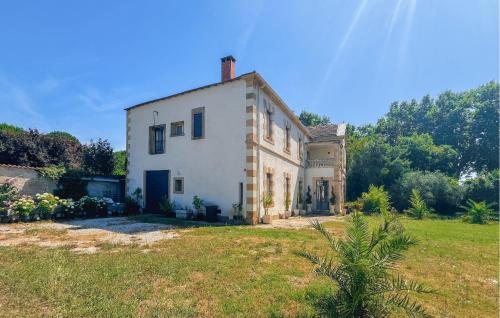 a large white house in a grassy field at Awesome Home In Connaux in Connaux