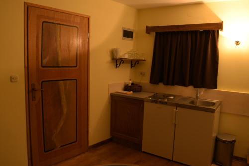 a small kitchen with a sink and a window at Kamene Priče rooms, music and food in Bale