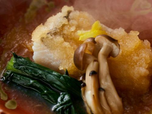 a bowl of soup with noodles and vegetables on it at KAMENOI HOTEL Fukui in Fukui