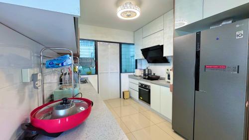 a bathroom with a red sink in a kitchen at Zeta Residence One South with City View n Private Lift, Seri Kembangan Selangor in Serdang