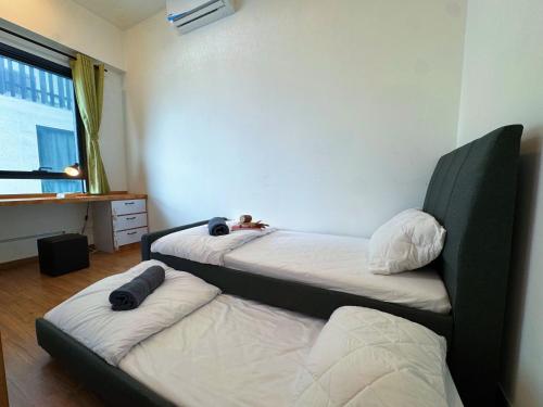 two beds in a room with a bedskirts at Zeta Residence One South with City View n Private Lift, Seri Kembangan Selangor in Serdang