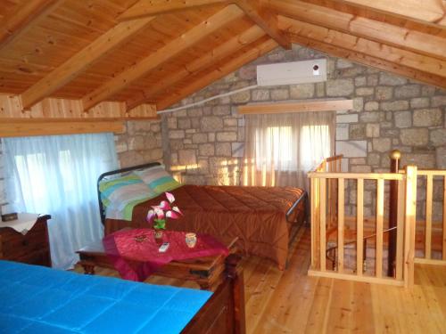 a bedroom with a bed and a table in a room at Menina Farm Kalamata Countryside in Perivolákia