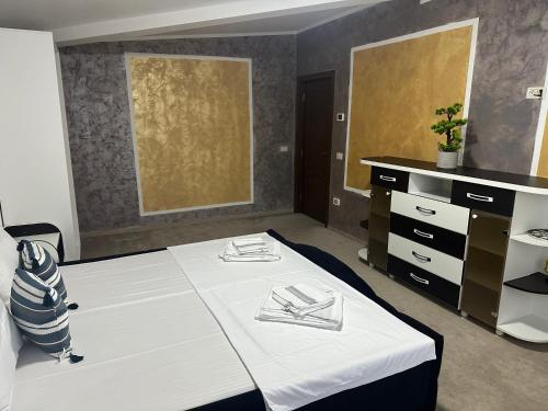 a room with a bed with two napkins on it at Riz apartamant in Bacău