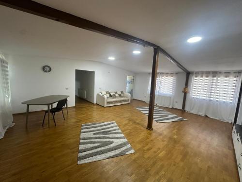 a living room with a table and a couch at Riz apartamant in Bacău