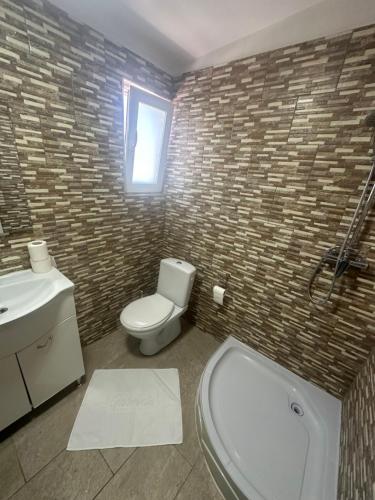 a bathroom with a toilet and a sink at Riz apartamant in Bacău