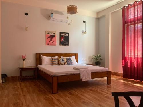 a bedroom with a bed and a red curtain at Rina's Homestay in Guwahati