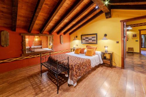 a bedroom with a bed in a room at Apartamentos Rurales & Spa La Bárcena in Enterria