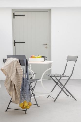 two chairs and a table in a room at Yposkafon Concept Two-Bedroom Villa with Private Jacuzzi and Hamam in Megalokhori