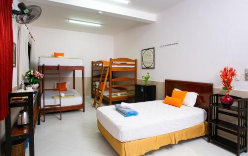 a bedroom with a bed and bunk beds in it at Cat Tien Jungle Lodge in Cat Tien