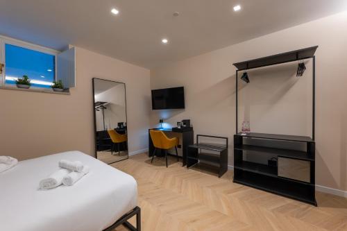 a hotel room with a bed and a desk at Luna Stay in Trieste