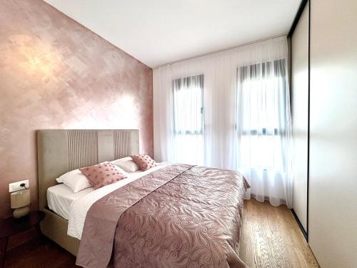 a bedroom with a bed and a large window at Apartment BAR M3A sea view in Bar