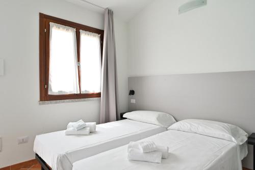 Postel nebo postele na pokoji v ubytování Residence Rocce Rosse
