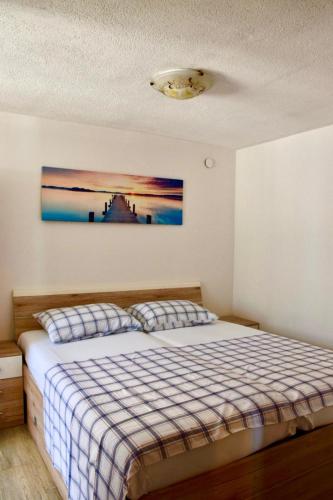 a bedroom with a bed and a painting on the wall at Holiday Home Babič in Zavala