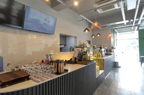 a restaurant with a counter with glasses on it at The Clover Hotel Angeles City in Angeles