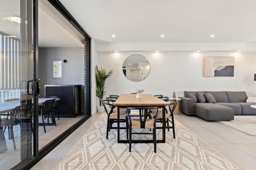 a living room with a table and a couch at Big Two-Story with Private Elevator & Balconies in Sydney