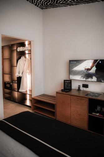 a living room with a tv and a closet at The Local House Alaçatı in Alacati