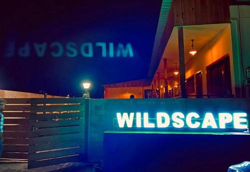 a blue sign that reads willnsics on the side of a building at Wildscape kaziranga in Kāziranga