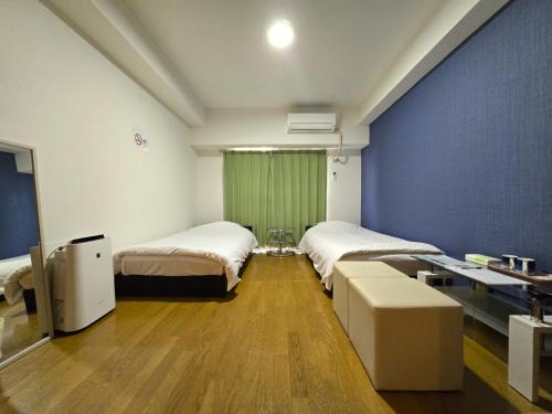 Ένα ή περισσότερα κρεβάτια σε δωμάτιο στο Comfort CUBE PHOENIX S KITATENJIN