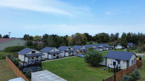an aerial view of a row of houses with a playground at Domki Asia - Muszelki 68 in Nowęcin