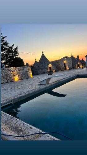 a pool of water in front of a building at Bed & breakfast vecchia vallata in Gioia del Colle