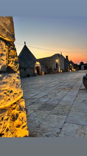 a stone building with a sunset in the background at Bed & breakfast vecchia vallata in Gioia del Colle