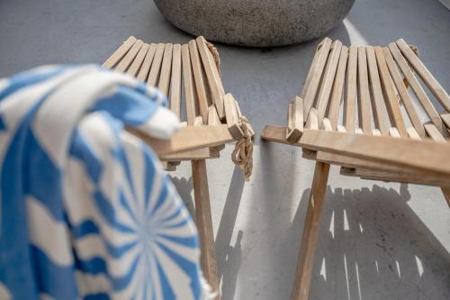 two wooden chairs sitting next to each other at Kampanario Luxury Two-Bedroom Villa with Private Jacuzzi in Megalokhori