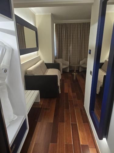 a living room with a couch and a chair at Grand Hotel Europa in Isernia