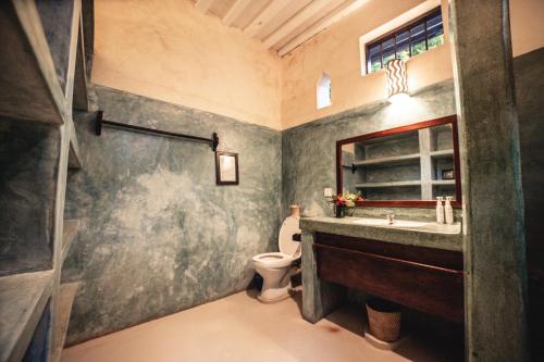 a bathroom with a sink and a toilet at Banana House and Wellness Centre in Lamu