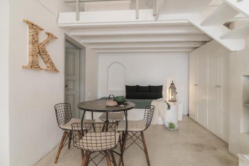 a dining room with a table and chairs at Kampanario Luxury Two-Bedroom Villa with Private Jacuzzi in Megalokhori