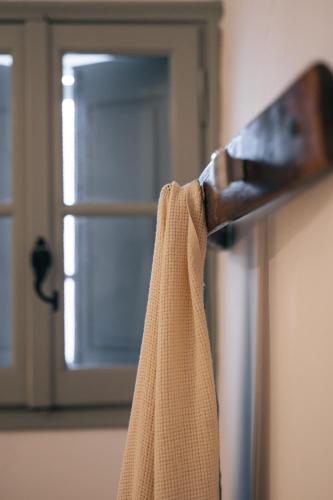 a towel hanging from a door handle with a window at Kampanario Luxury Two-Bedroom Villa with Private Jacuzzi in Megalokhori