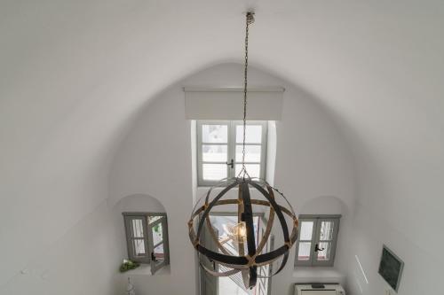 a orb light fixture hanging from a white wall at Kampanario Luxury Two-Bedroom Villa with Private Jacuzzi in Megalokhori