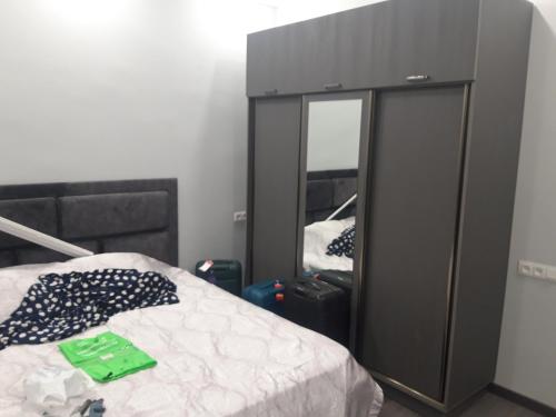 a bedroom with a bed and a large mirror at Arm Garden in Aghk'ilisa