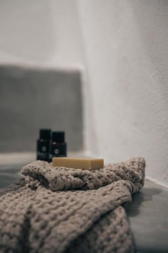 a blanket and two candles on a bed at Yposkafon Concept Two-Bedroom Villa with Private Jacuzzi and Hamam in Megalokhori