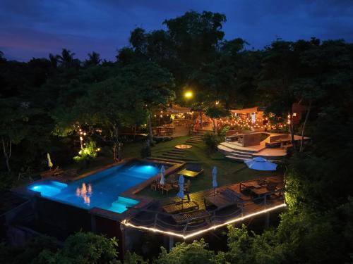 an overhead view of a swimming pool at night at Nakabalo Guesthouse & Restaurant in Siquijor