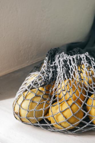 a net with oranges in it on a floor at Yposkafon Concept Two-Bedroom Villa with Private Jacuzzi and Hamam in Megalokhori