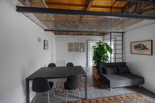 a dining room with a black table and chairs at Suites della Giudecca in Catania