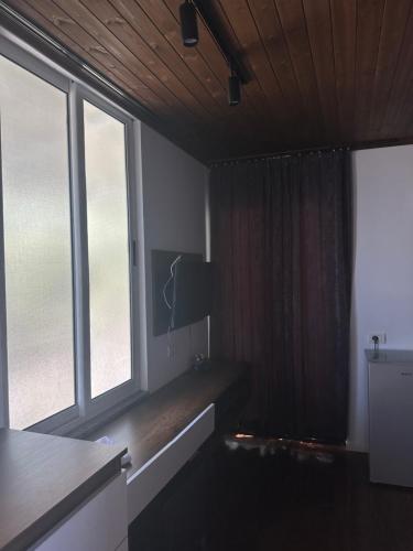 a living room with two large windows and a table at SEA bed and restaurant 1 in Borsh