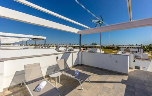 a balcony with two chairs and a view of the ocean at Amazing Home In San Javier in San Javier