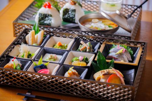 a tray of sushi and other food on a table at Hotel Monterey Sendai in Sendai