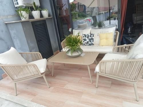 a patio with chairs and a table and a table at Alojamento do Canto in Viana do Castelo