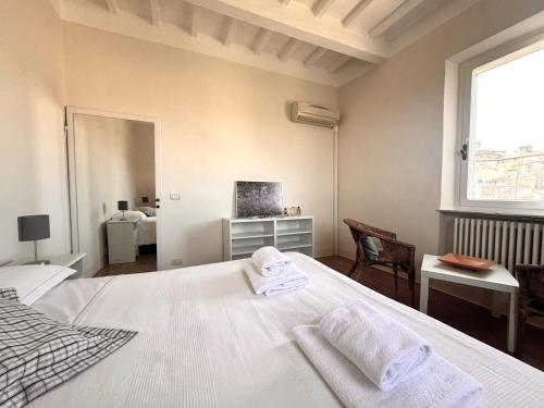 Voodi või voodid majutusasutuse Dimora con vista sulla Torre del Mangia toas