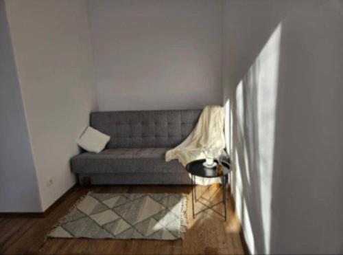 a living room with a couch and a table at Kawalerka Krasińskiego in Kraśnik