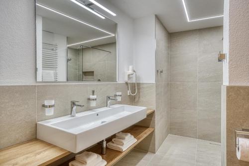 a bathroom with a white sink and a mirror at Haus St. Bernard in Pettneu am Arlberg